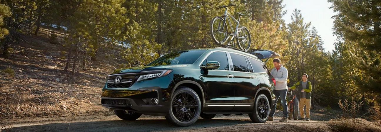 Black 2019 Honda Pilot parked on forest trail